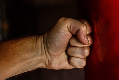 Domestic Violence Icon - Clenched Fist Punching a Wall