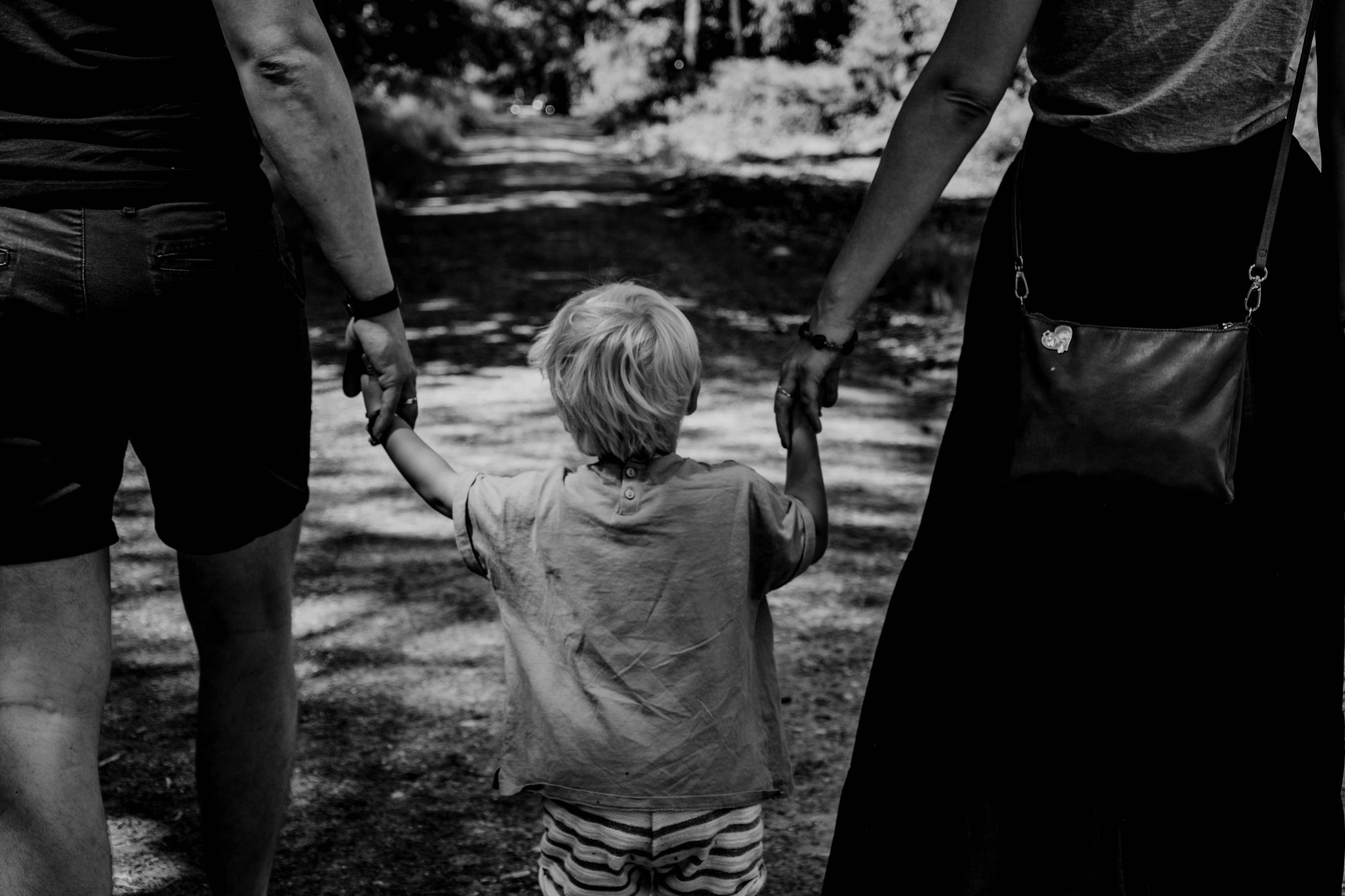 Parents walking child.