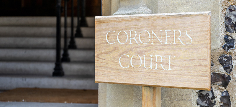 Wooden sign reading coroners court
